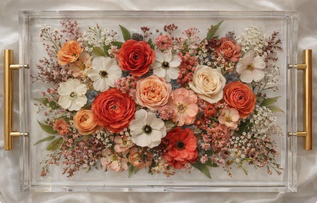 Bridal bouquet preservation in acrylic tray with a custom flower arrangement in resin on a neutral background