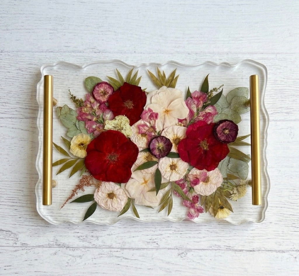 Large rectangular scalloped-edge resin tray used for floral preservation with preserved pink and white wedding flowers and gold hardware.