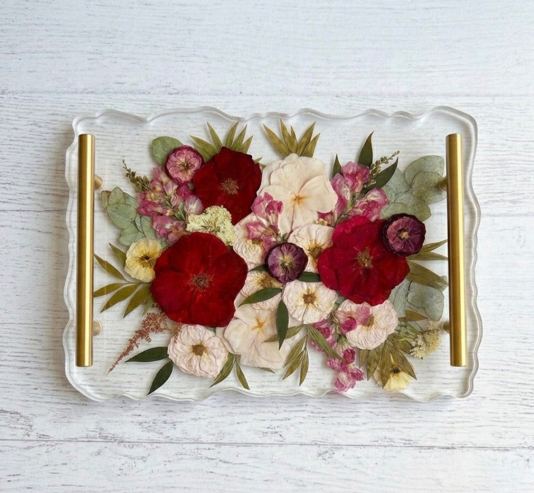 Large rectangular scalloped-edge resin tray used for floral preservation with preserved pink and white wedding flowers and gold hardware.